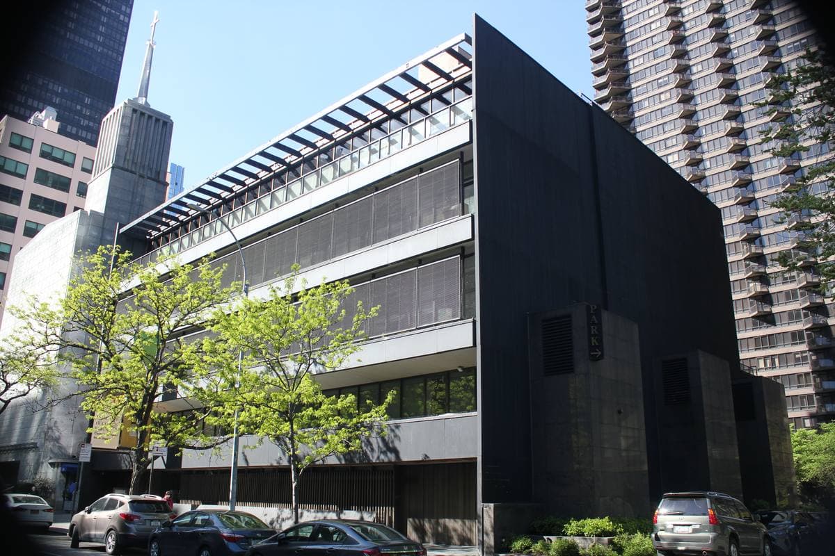 A dark modernist building front with horizontal louvres on a Manhattan street