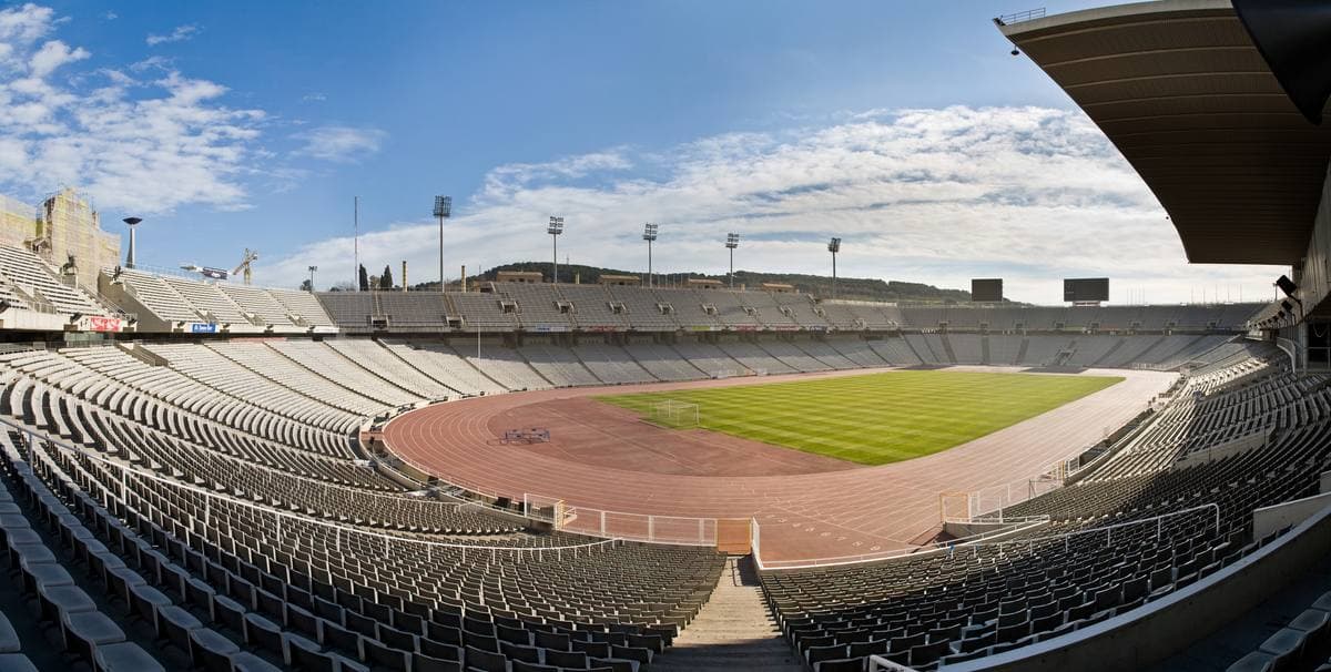 The inside of a stadium bowl with tiers of seats around a running track