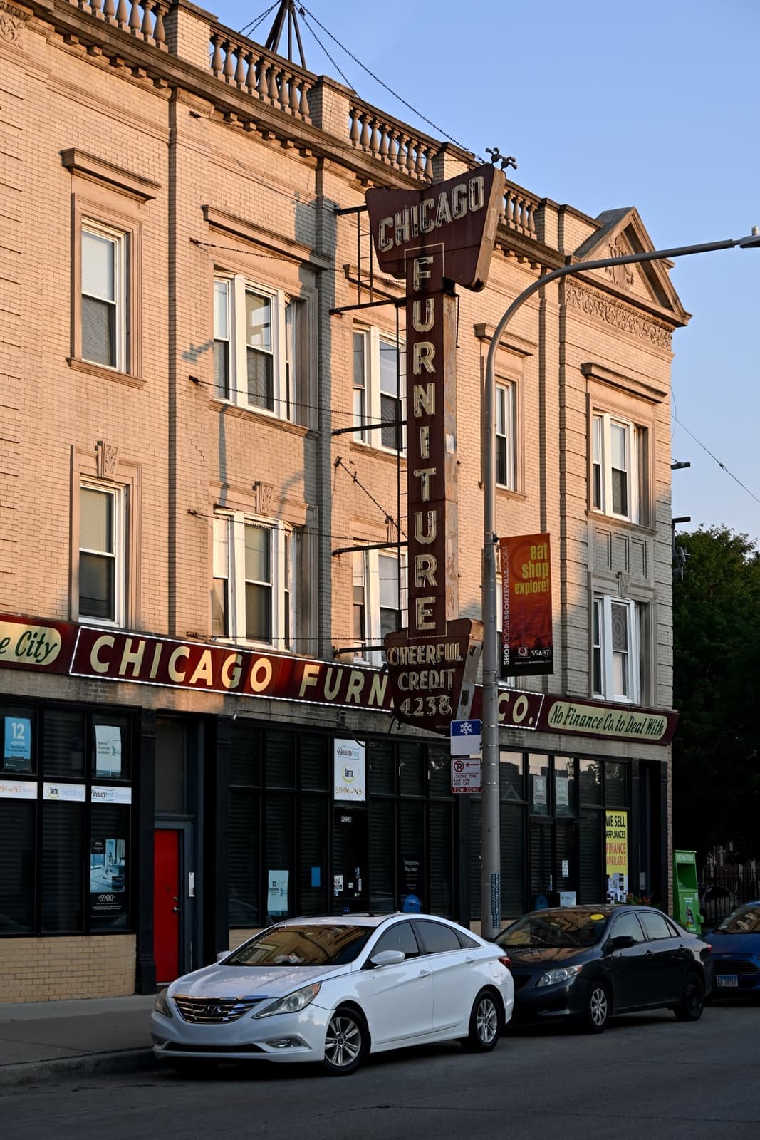 Brick buildings with vintage painted signs on Cottage Grove Avenue in evening light