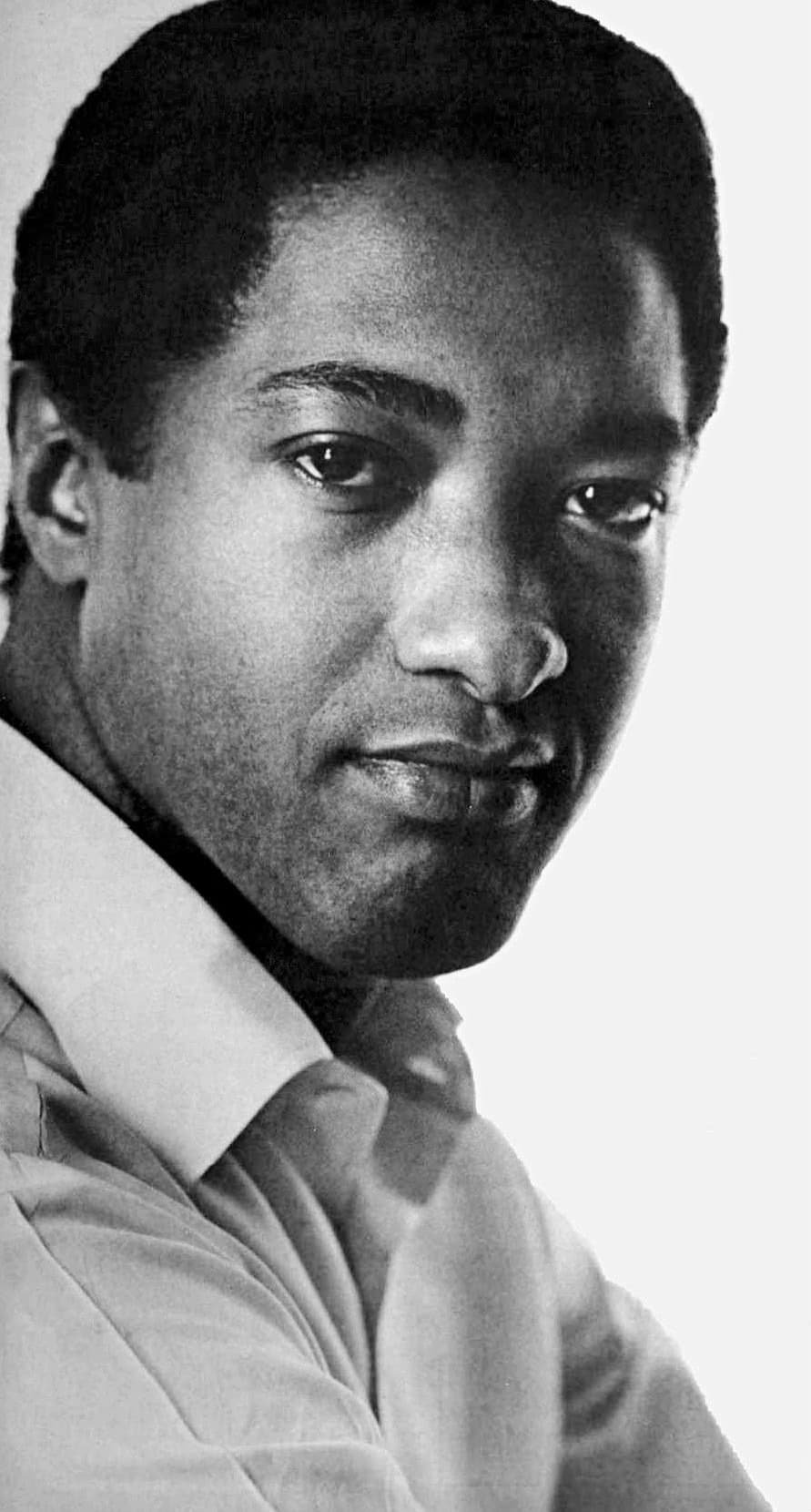 A close portrait of Sam Cooke in an open-necked shirt, looking straight at the camera