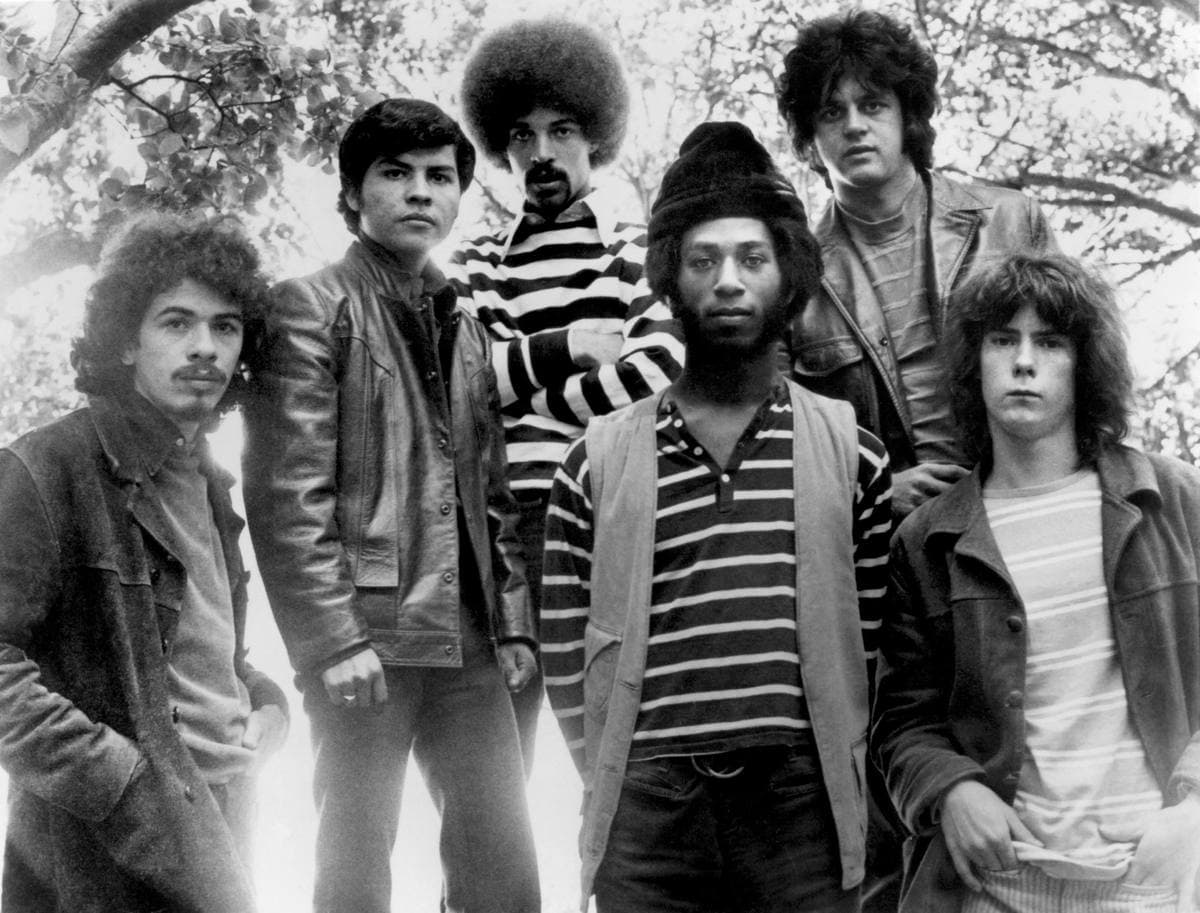 Six young musicians posed together in a black-and-white 1969 press photograph