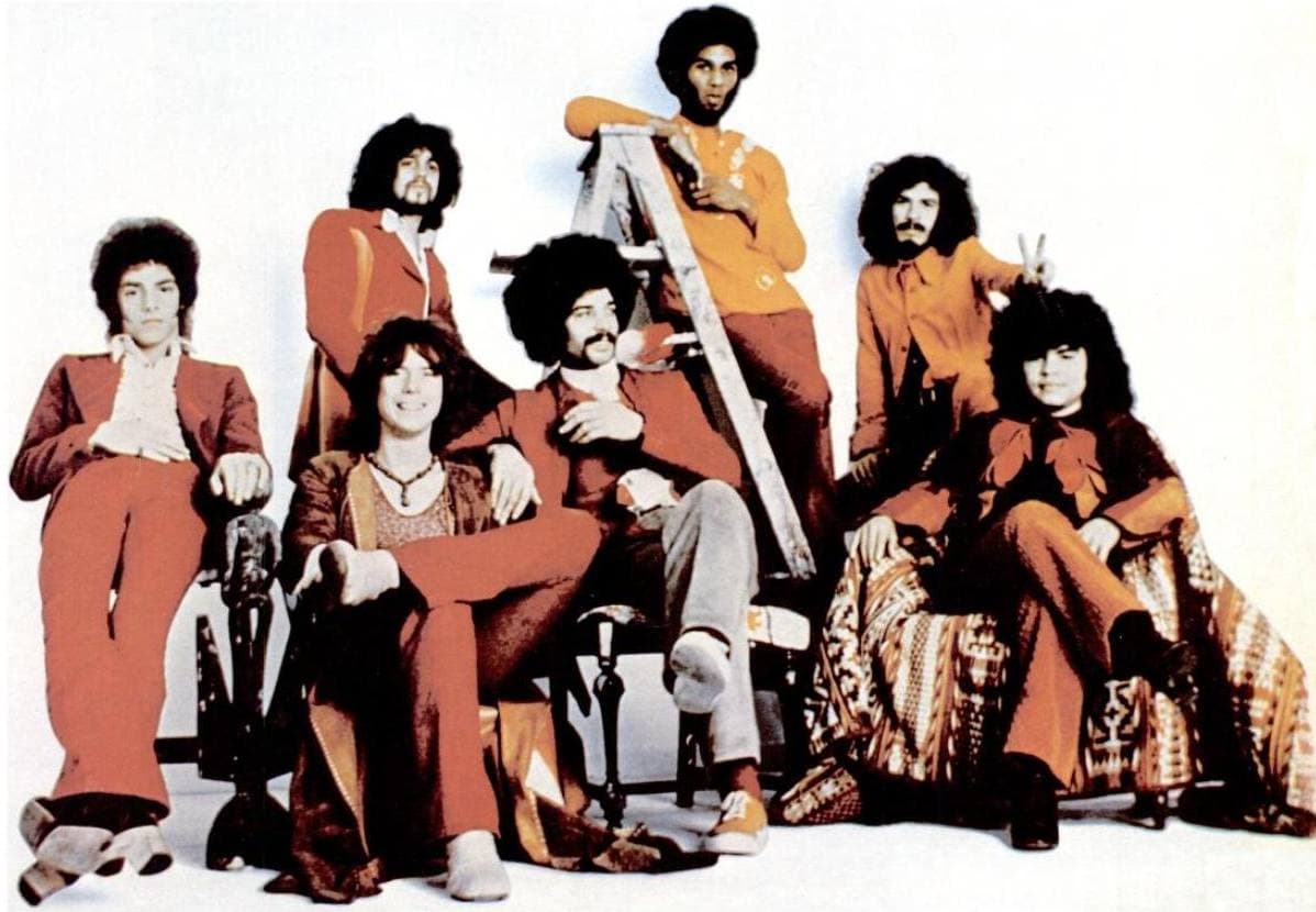 The band posed outdoors in a black-and-white 1971 advertisement photograph