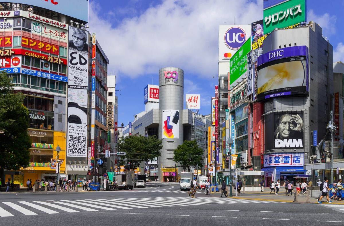 The cylindrical tower of the Shibuya 109 building at a road fork