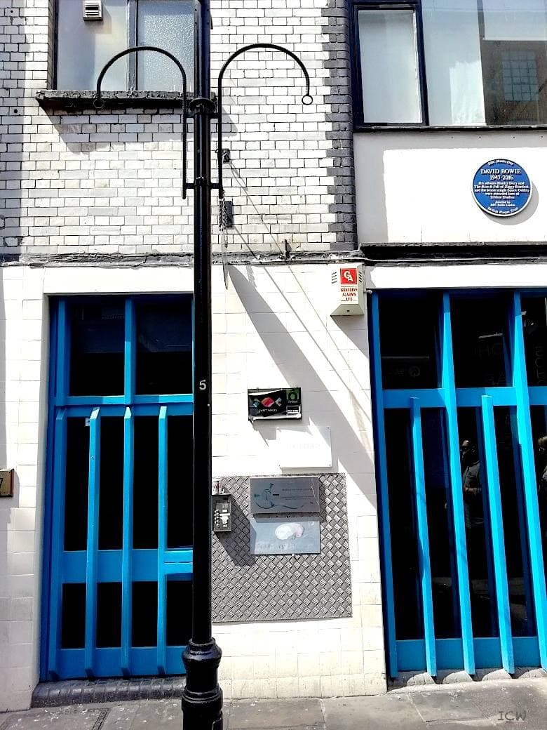 A narrow Soho building with a blue plaque