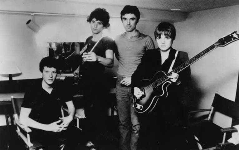 The four members of Talking Heads with instruments in a rehearsal room