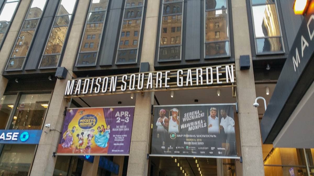 The lettered entrance of Madison Square Garden above a street of banners