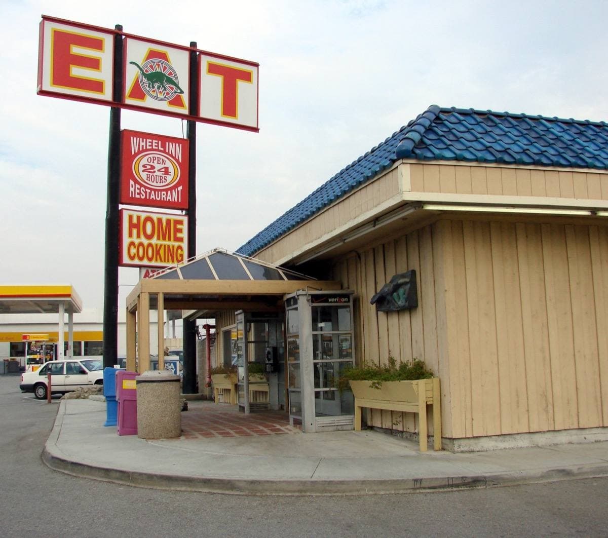 The low roadside Wheel Inn café with its sign beside the freeway at Cabazon