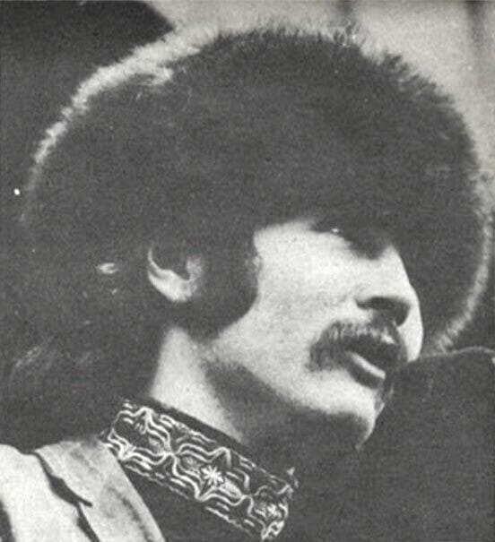 A young man with a moustache in a wide-brimmed hat, black and white
