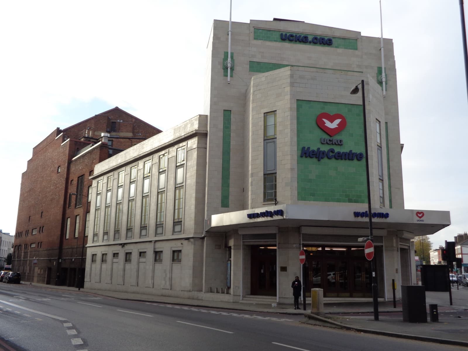 A pale art deco theatre front on a street corner