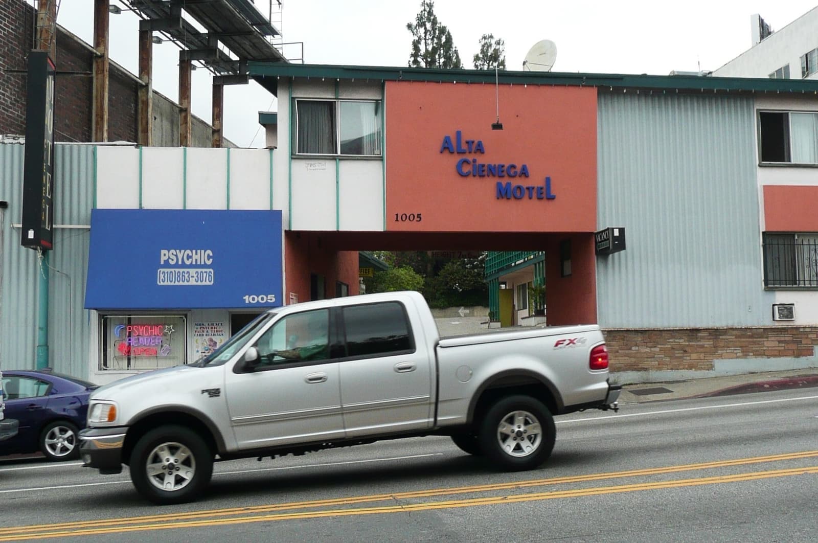 A small two-storey motel with a sign on the corner of La Cienega Boulevard