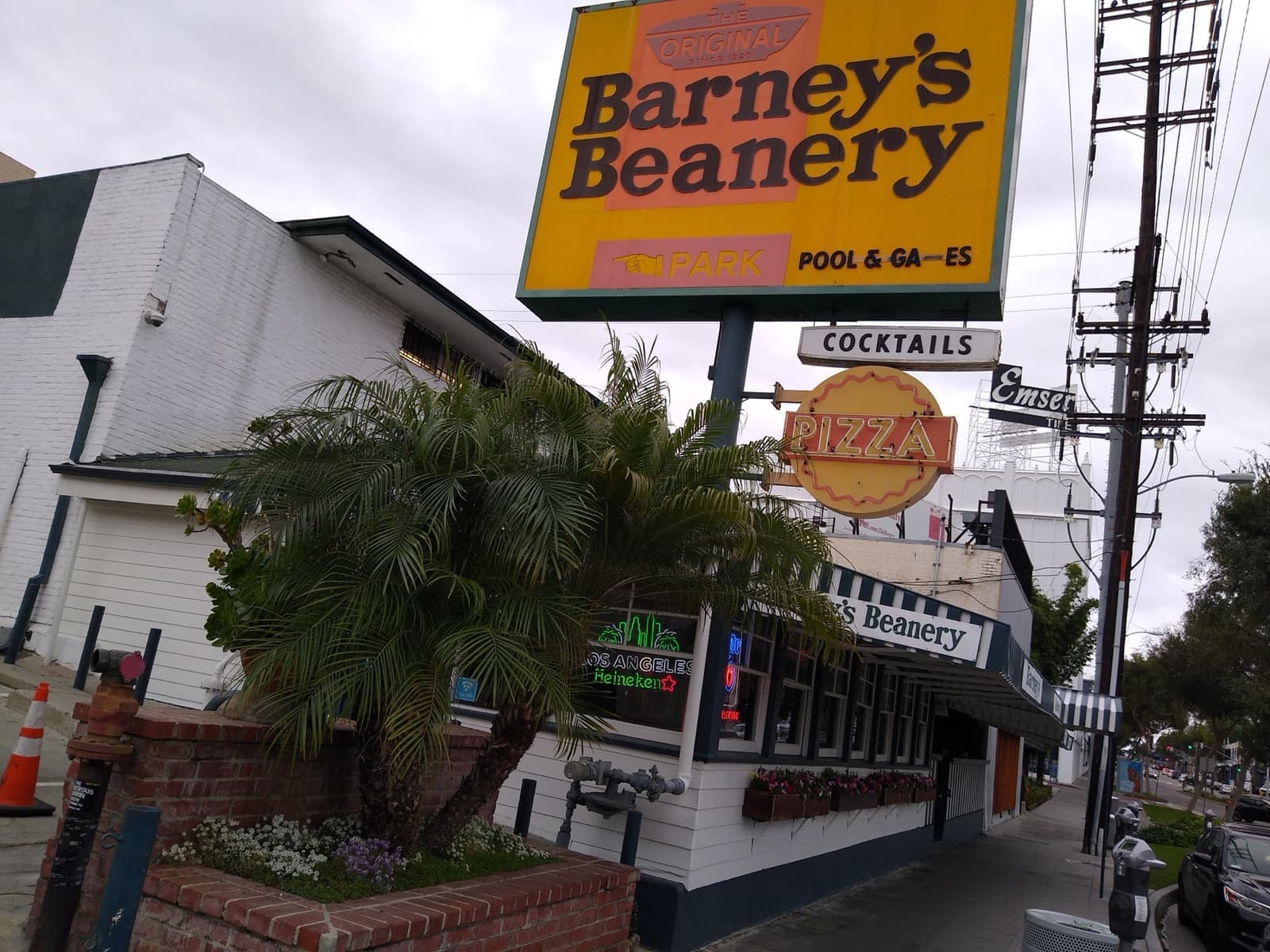 The front of Barney's Beanery, a low roadhouse with a painted sign