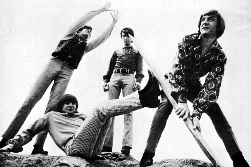 The four Monkees in action with instruments, from a 1967 album advert