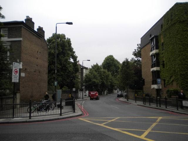 A Chelsea street of brick terraces and trees, yellow box junction in front