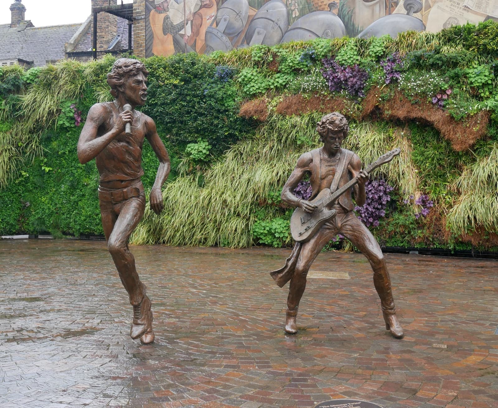 Bronze statues of Mick Jagger singing and Keith Richards playing guitar