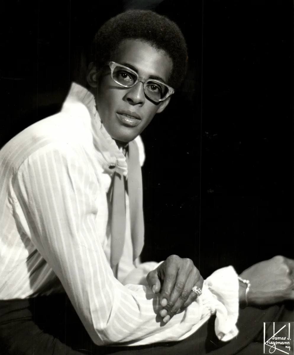 David Ruffin in glasses and a ruffled pale shirt, seated