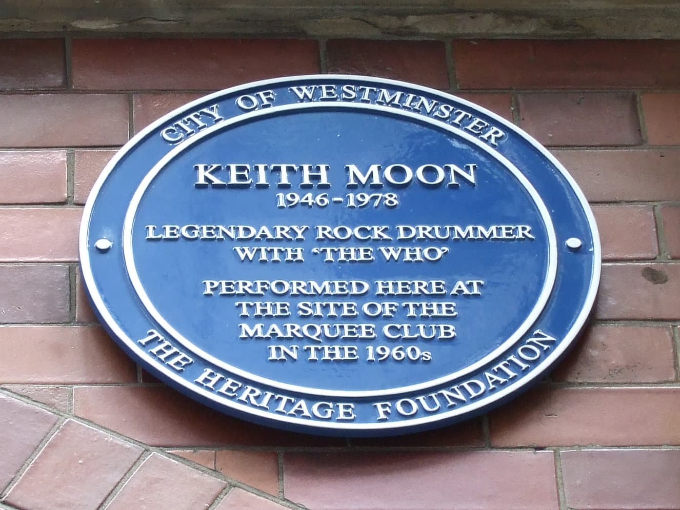 A blue City of Westminster plaque for Keith Moon on red brick