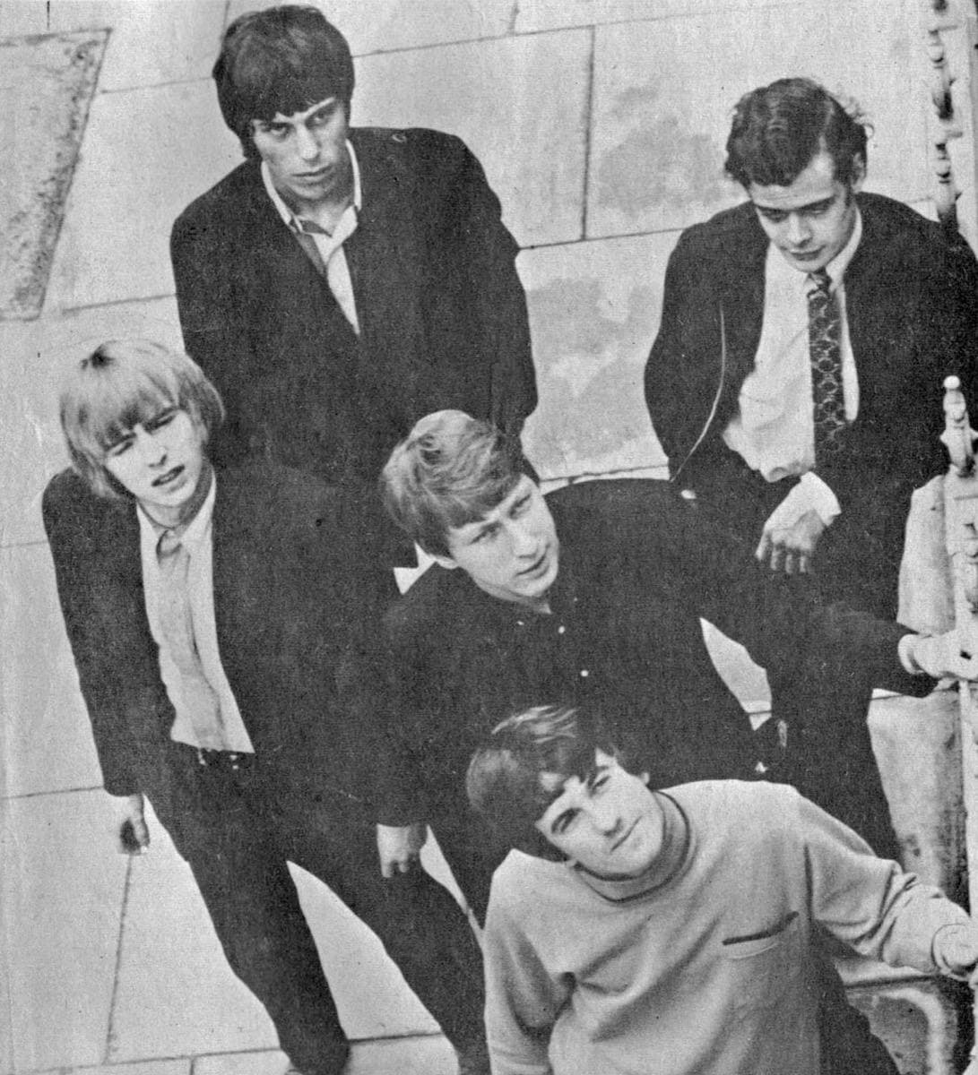 Five young men in a stacked group portrait, black and white