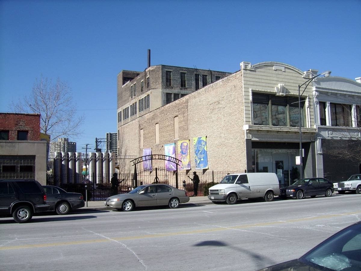 A narrow brick and stone building front on a city street