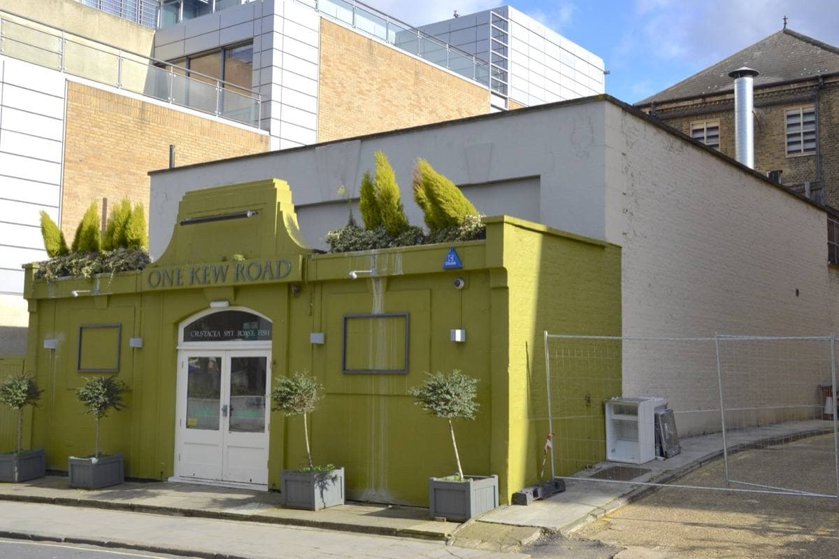 A low painted building on a street corner