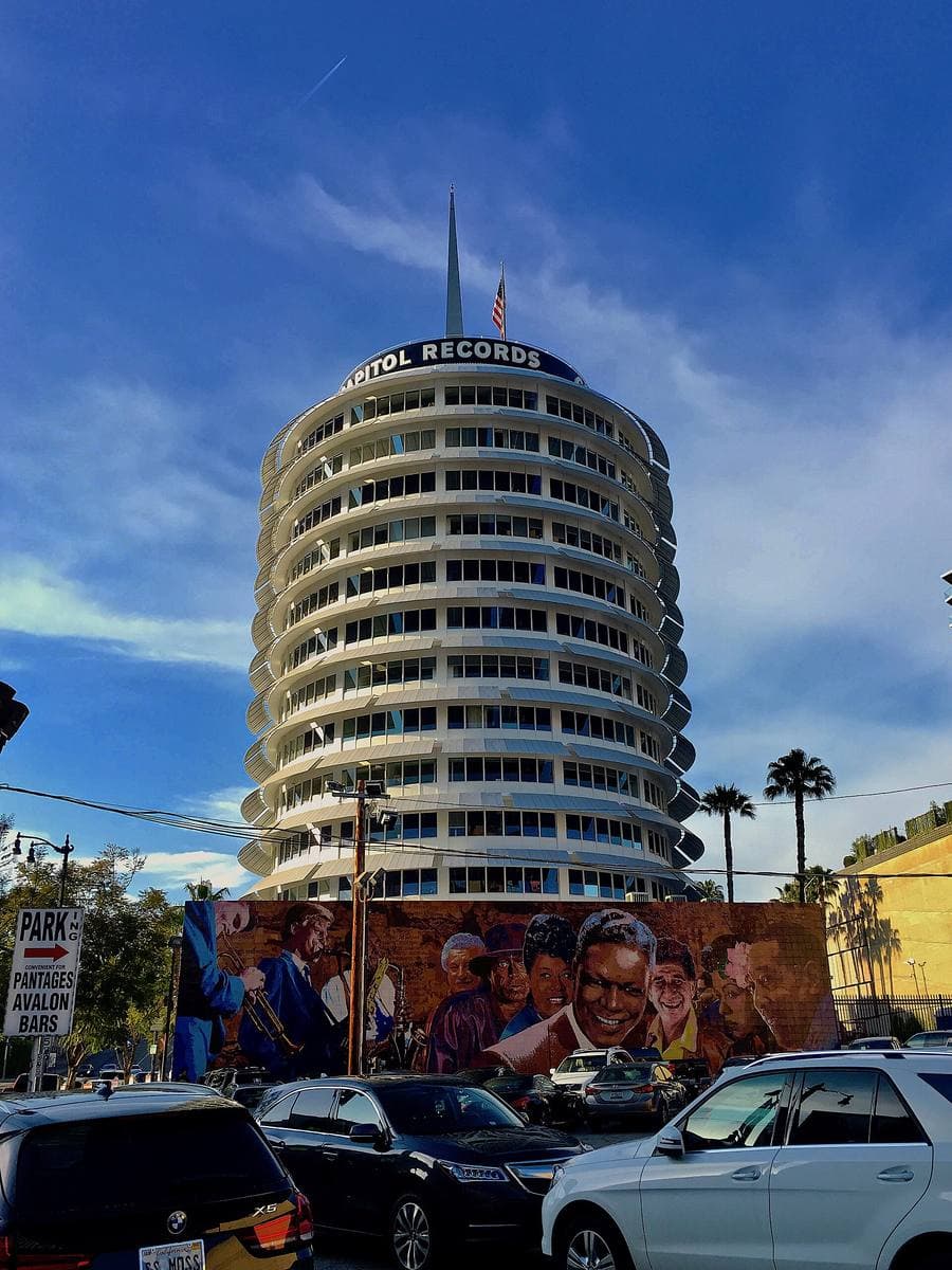 The round Capitol Records tower with its stacked curved awnings against blue sky