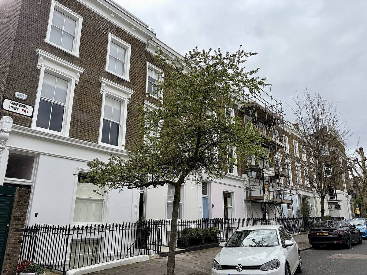 A row of white-stuccoed Victorian houses on a quiet London street
