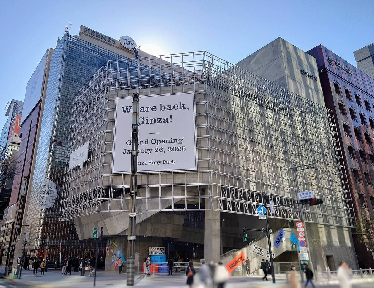 A low glass and concrete building on a busy Ginza crossing