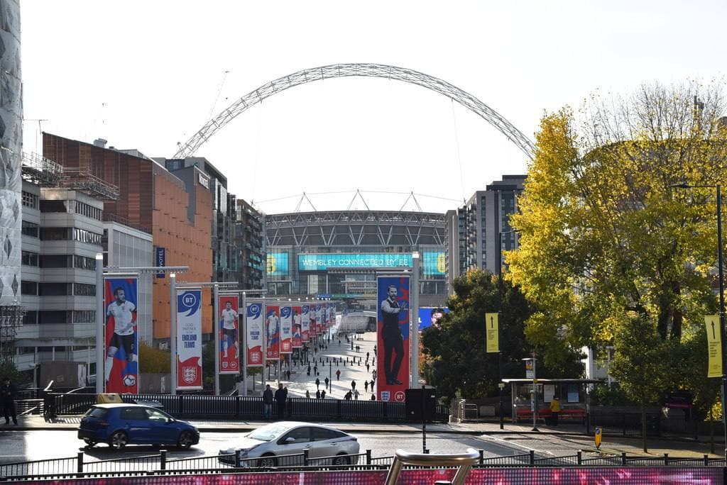 The long straight walkway of Olympic Way leading to Wembley Stadium and its white arch