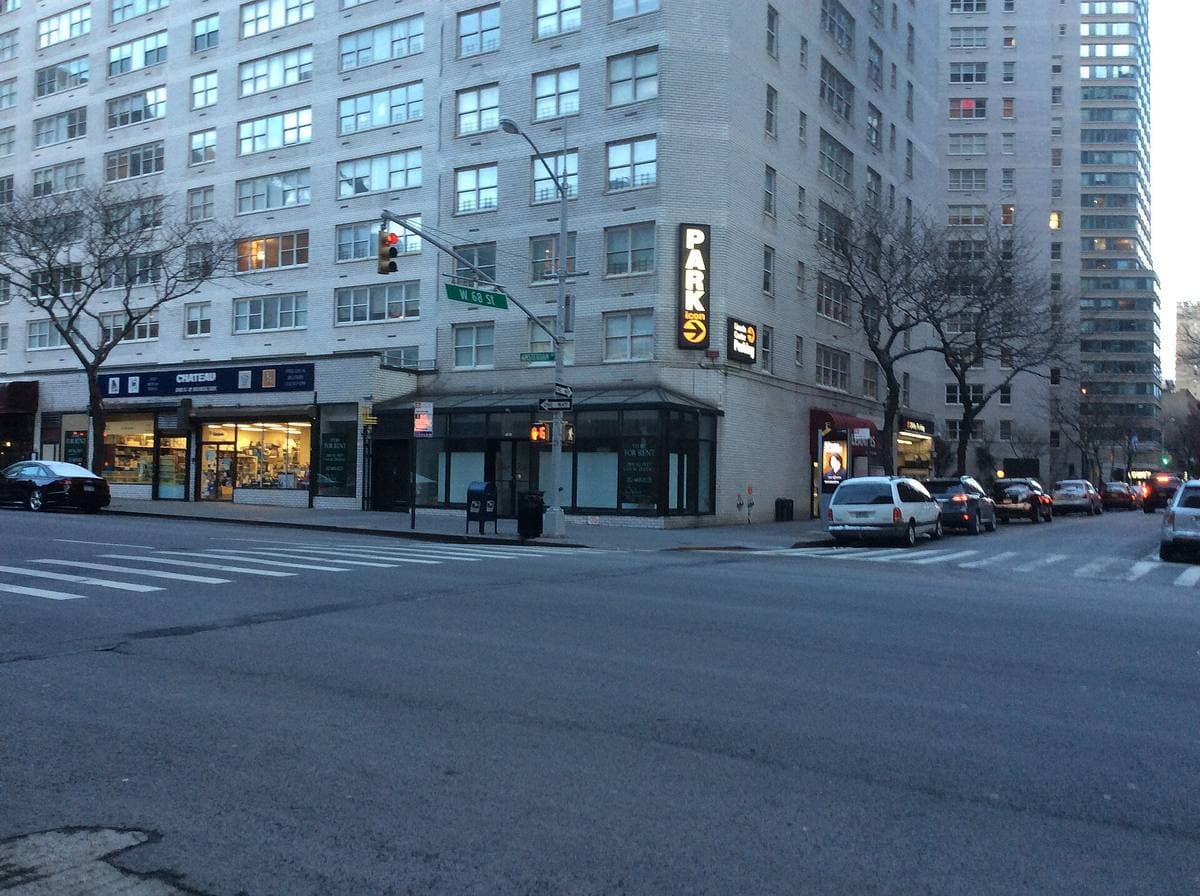 A city street corner with apartment blocks and shopfronts on Amsterdam Avenue