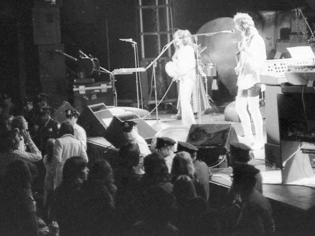 Yes on stage in 1974 under coloured light