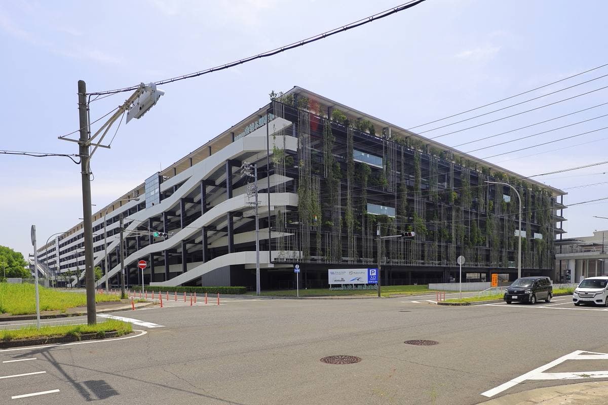 A long multi-storey car park with wavy white louvres along its face