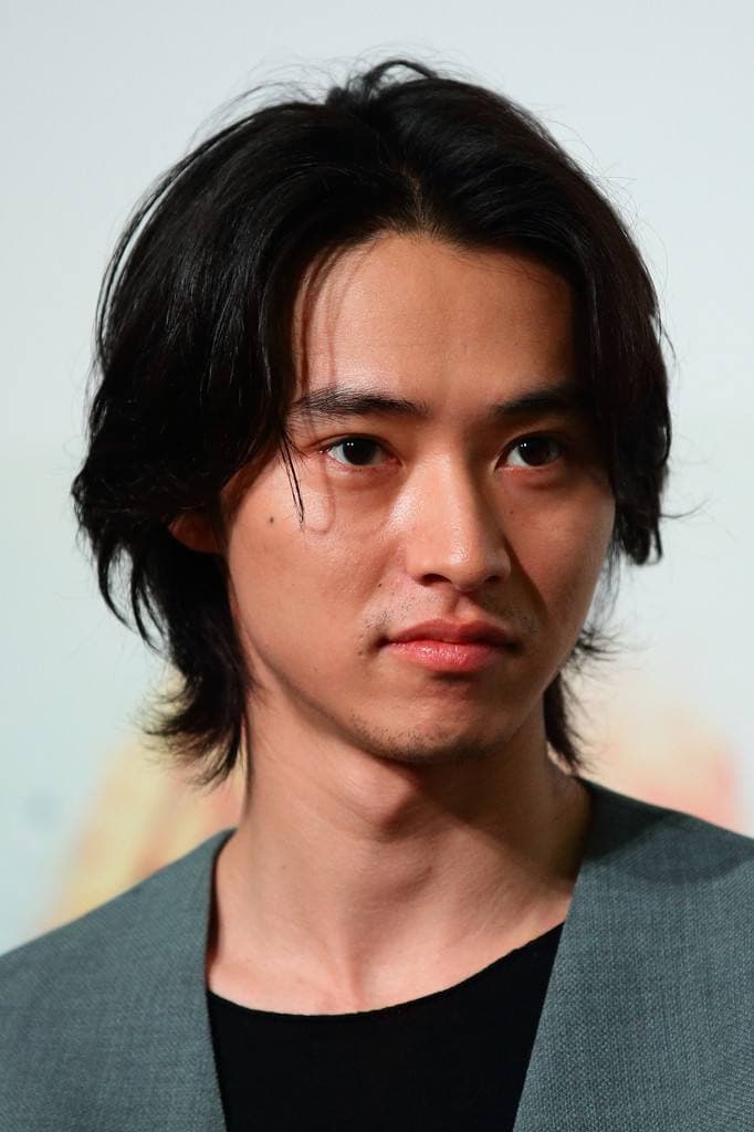 Kento Yamazaki, shoulder-length dark hair, in a grey jacket over a black top