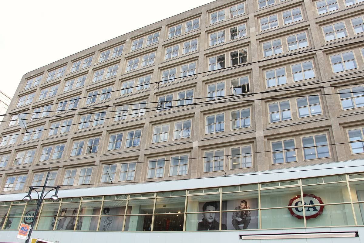 Rows of identical windows on a pale stone office block