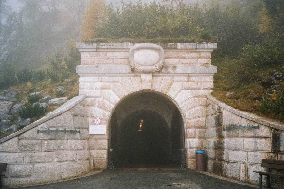 A stone portal into the mountain with bronze doors