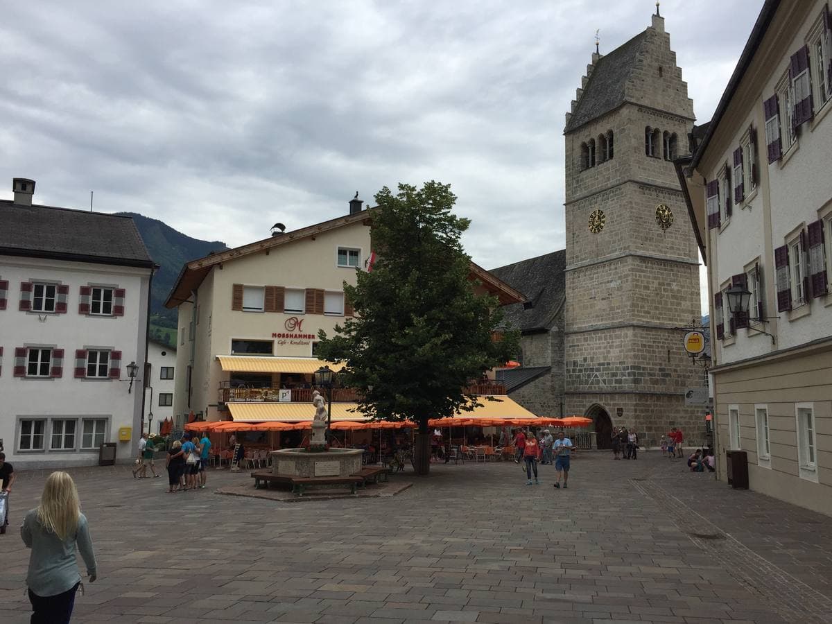Old town houses and a church tower beside the lake