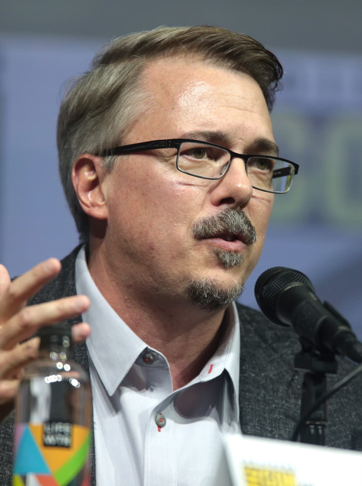 Vince Gilligan in glasses speaking at a panel