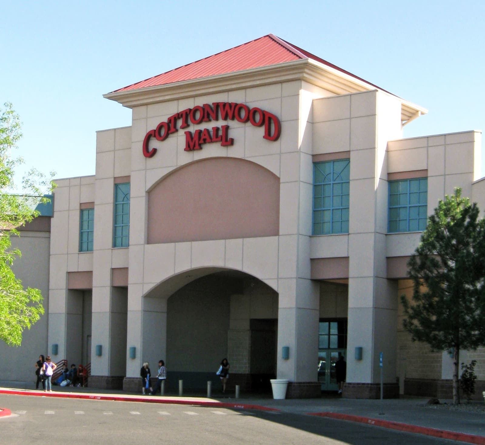 The arched entrance of Cottonwood Mall with its name in red letters