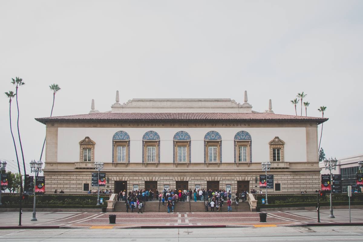 A grand 1930s auditorium front with arched windows at dusk