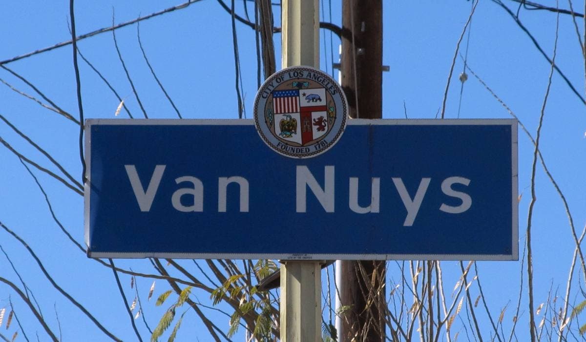 Blue Los Angeles neighbourhood sign reading Van Nuys on a street pole
