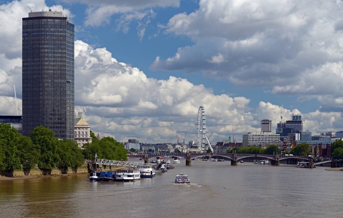 The red Lambeth Bridge across the Thames with Millbank Tower beyond