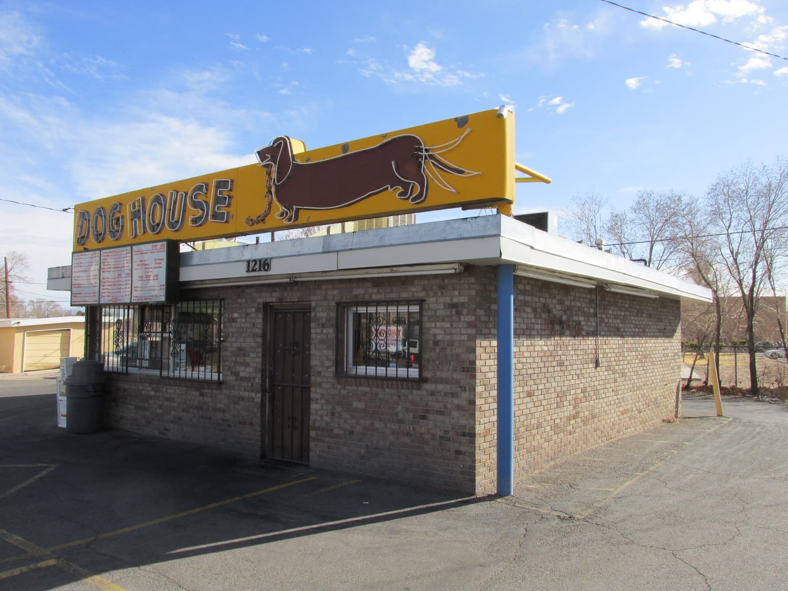 A small brick drive-in with a long sign of a dachshund