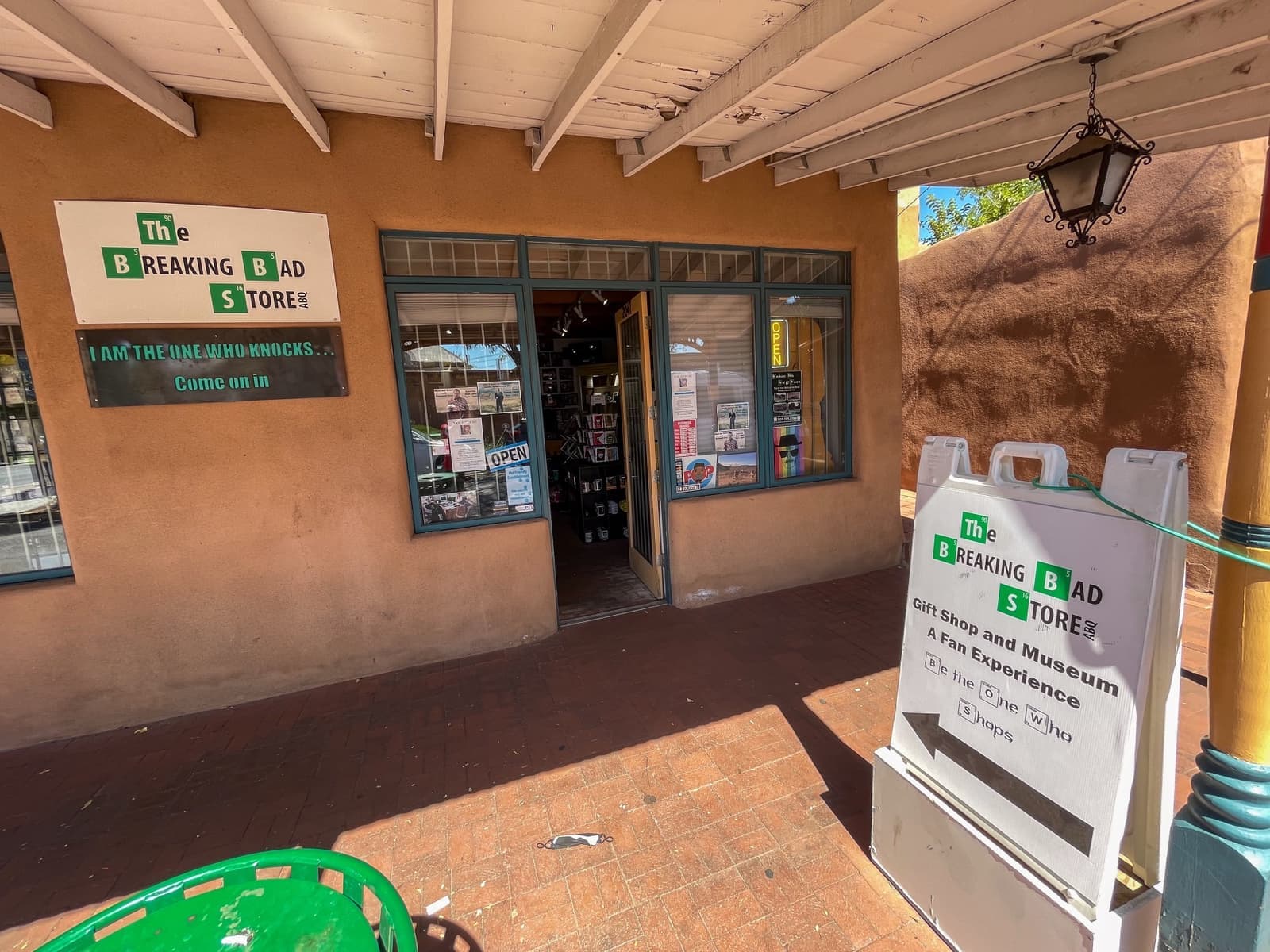 An adobe shopfront in Old Town with the store’s signs at the door