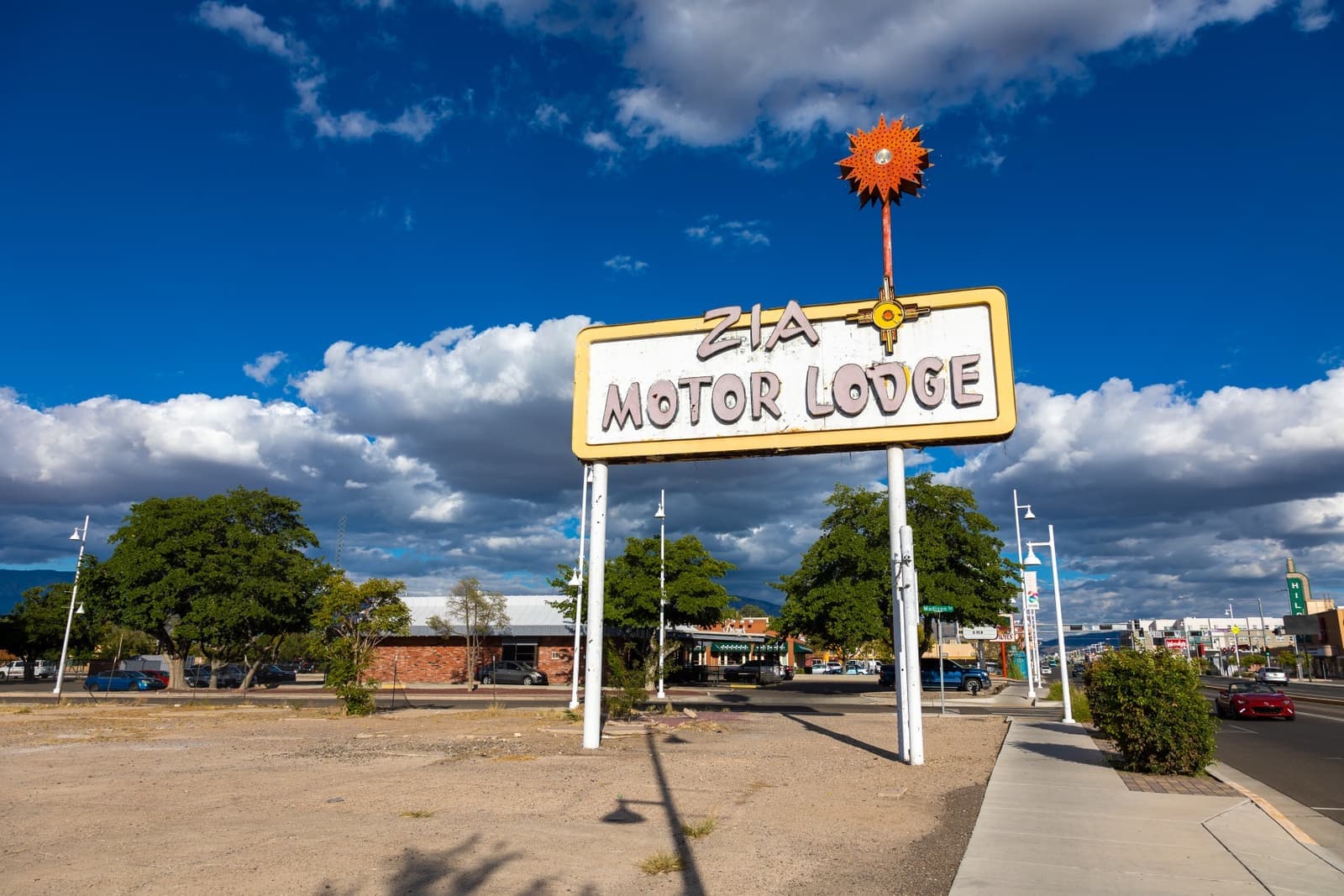 A tall roadside motel sign standing alone
