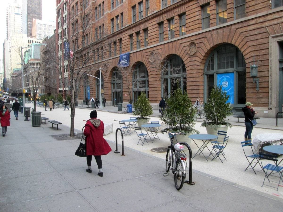 A pedestrian street between tall college buildings
