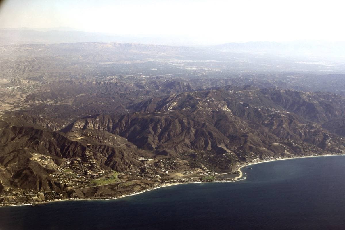 The Malibu coast with houses above the beach and the Pacific beyond