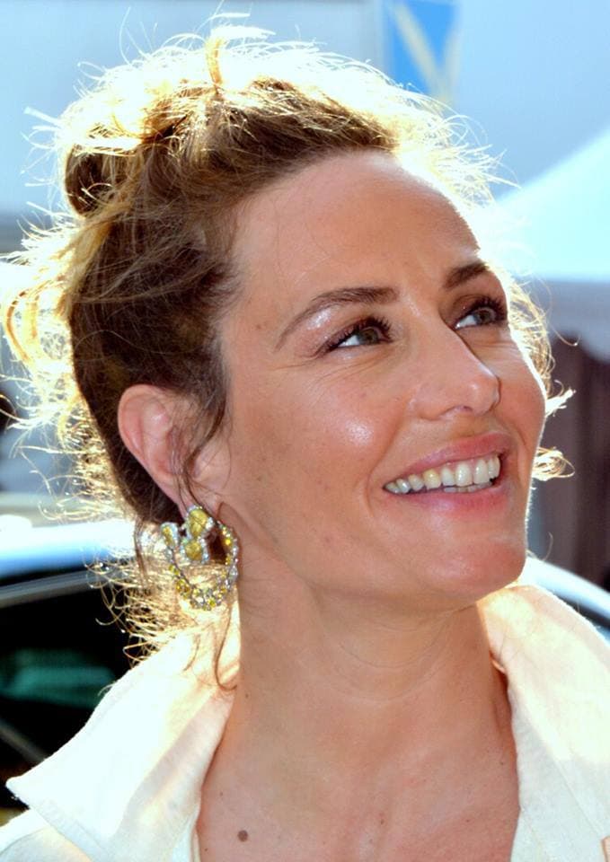 Cécile de France laughing, her hair pinned up, in sunlight at Cannes