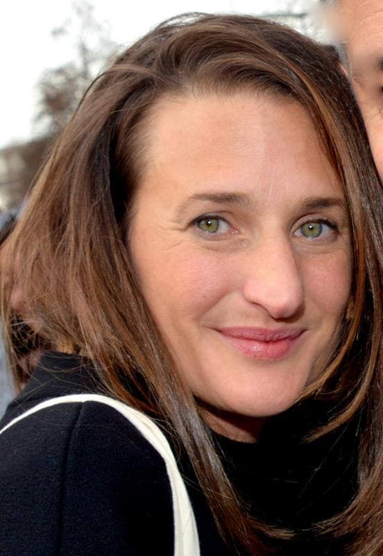 Camille Cottin, long brown hair, smiling slightly, close up