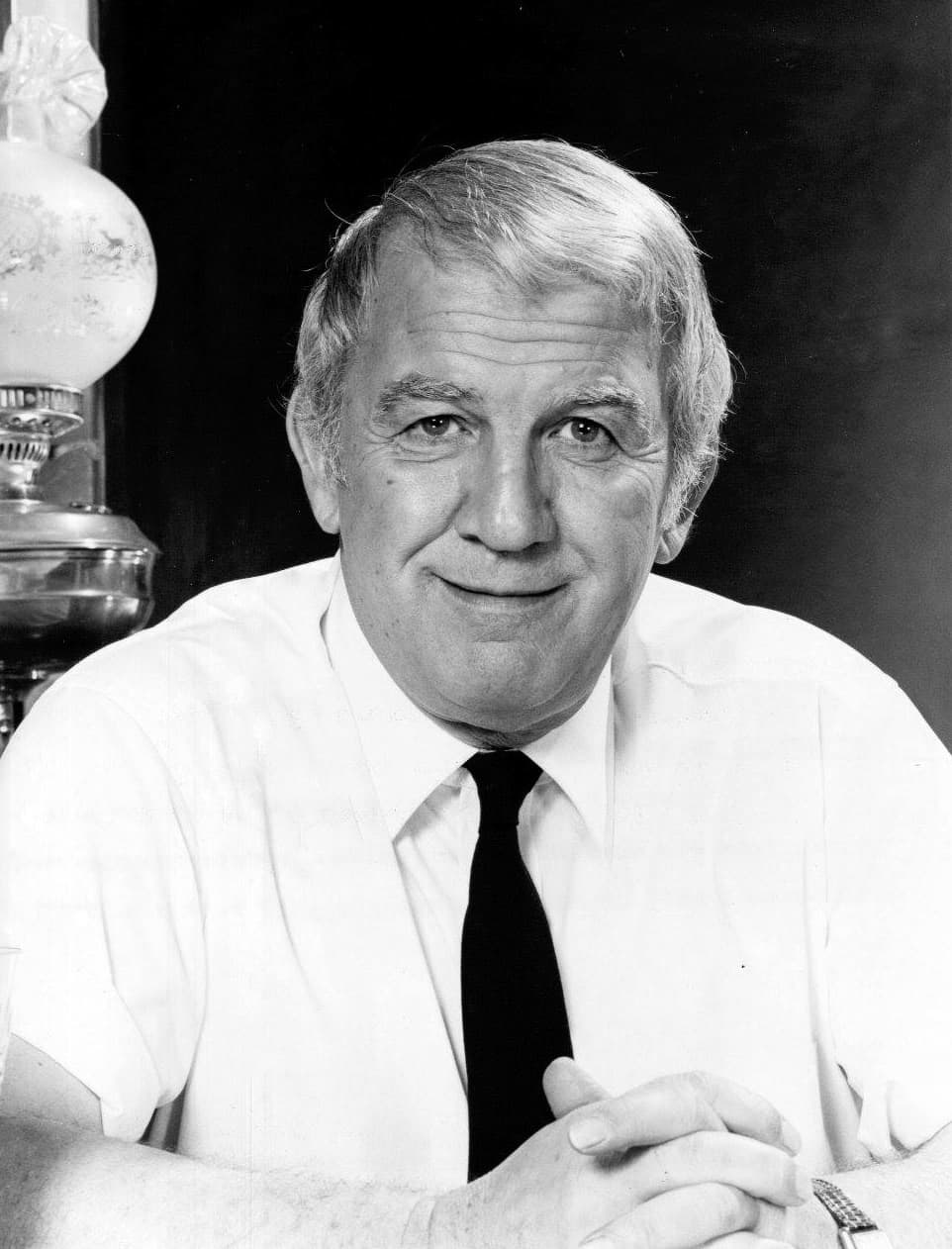 Black-and-white portrait of Nicholas Colasanto, grey hair, white shirt and dark tie