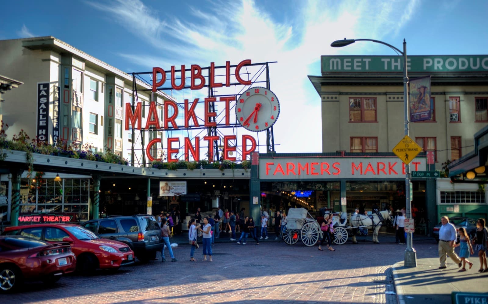The red neon Public Market Center sign and clock over the market entrance