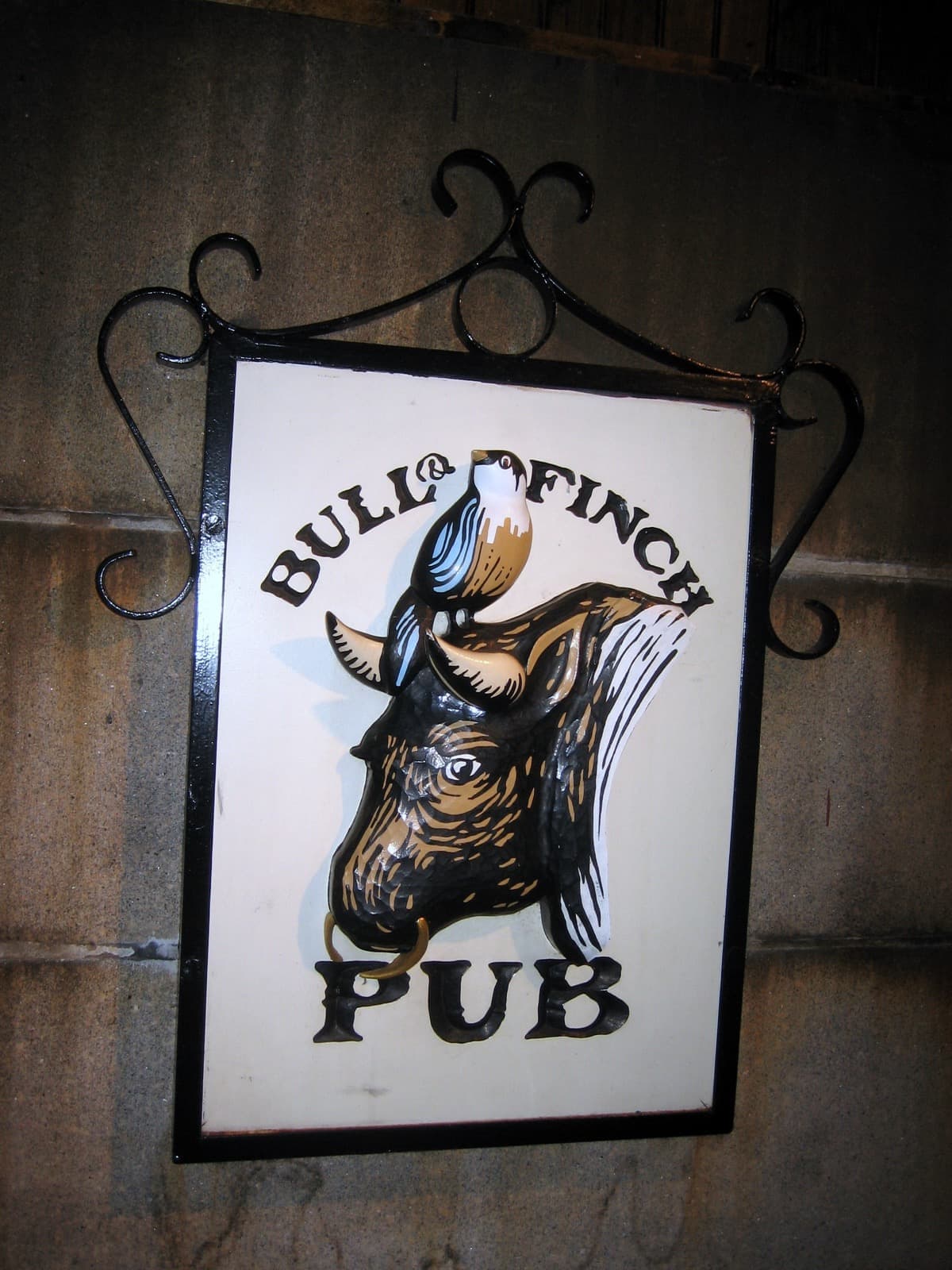 A painted hanging sign of a bull’s head with a finch on its horns, lettered Bull & Finch Pub