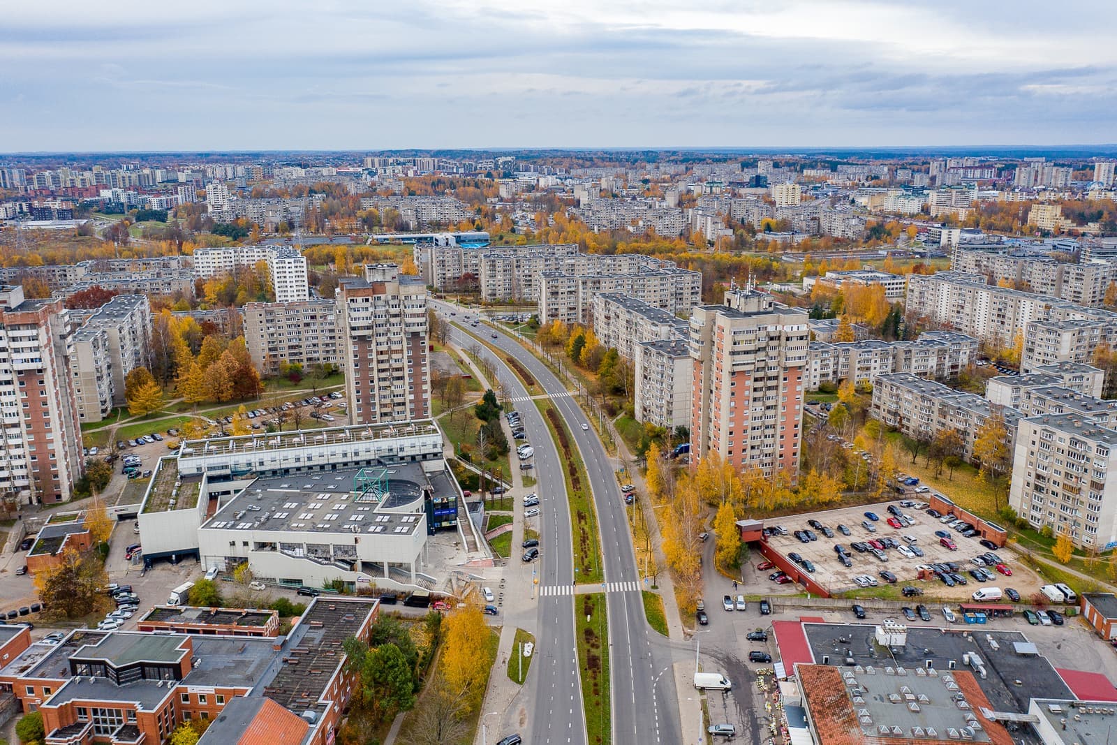 Apartment blocks either side of a wide road in Justiniškės